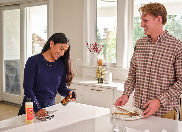Two people cleaning with on guard cleaners