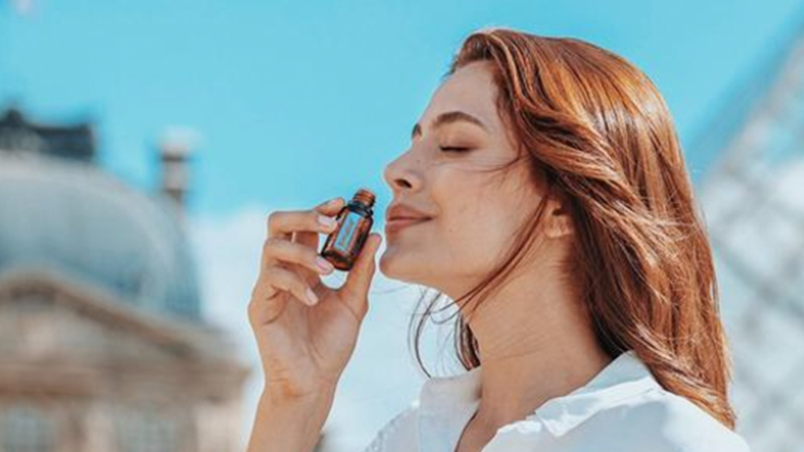 A woman smelling doTERRA Breathe essential oil
