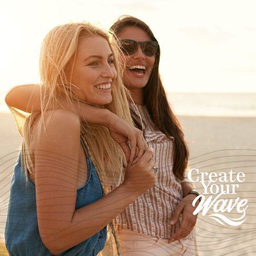 Two women embracing on a beach