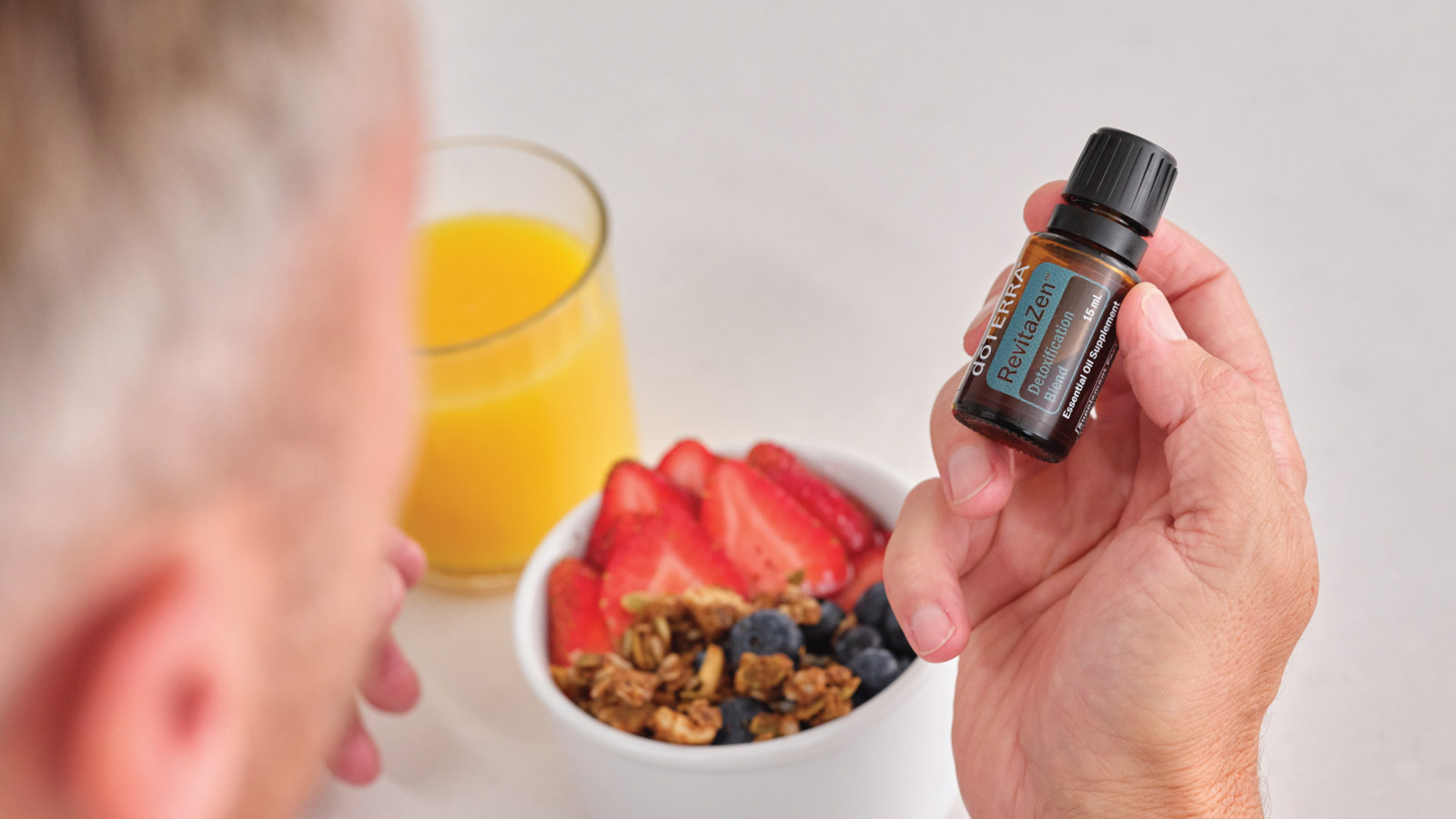 A person holding doTERRA RevitaZen