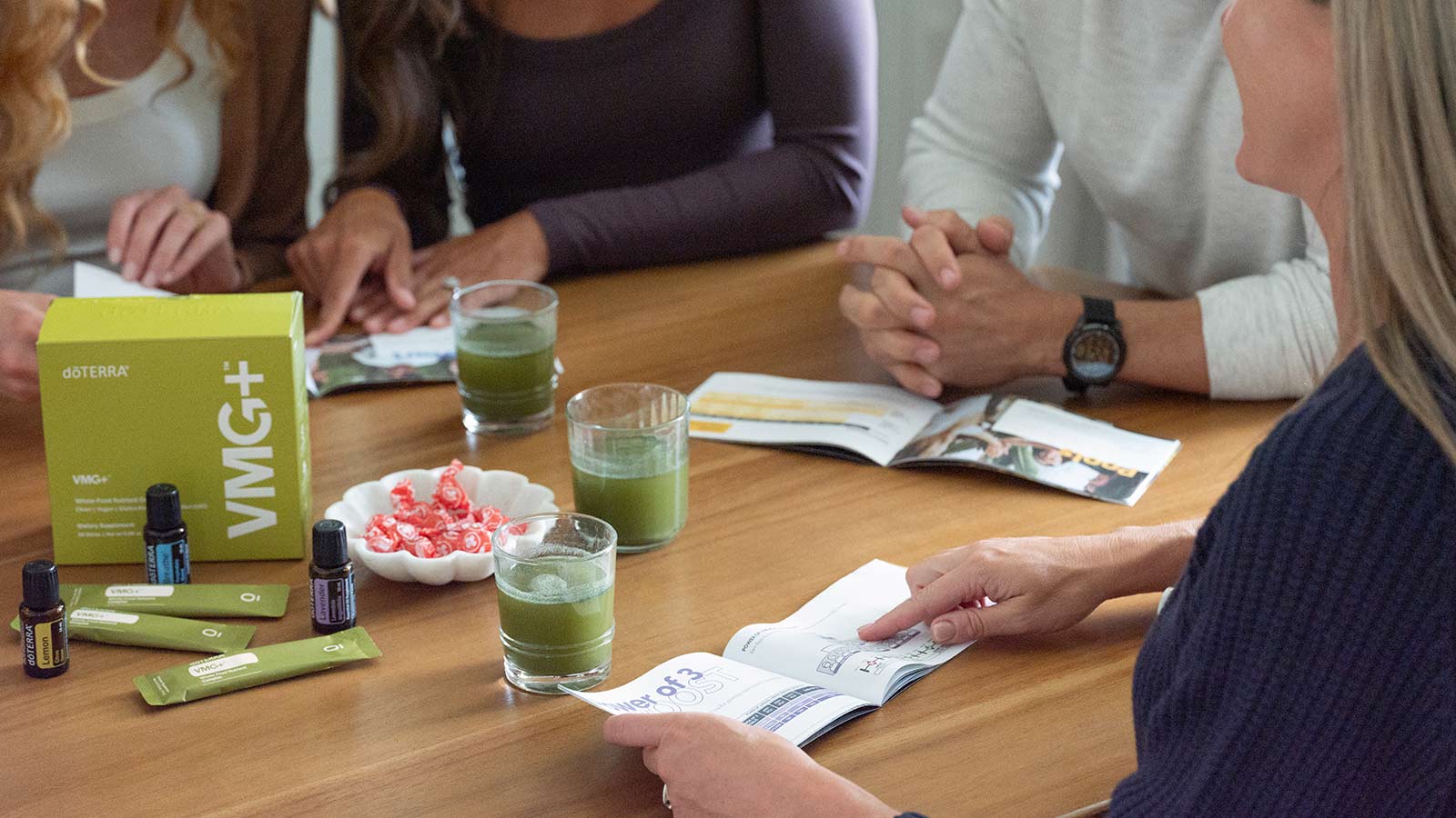 People around a table with VMG and doTERRA essential oils