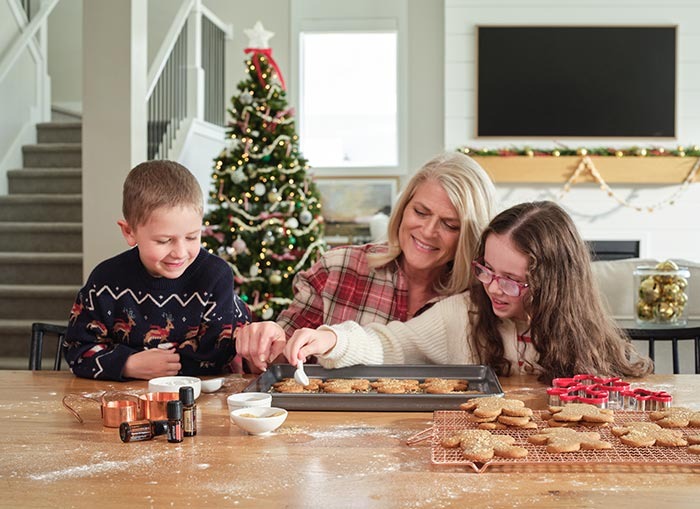 Grandmother making gingerbread men with grandchildren