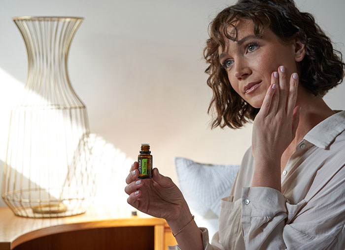 Woman Applying Tea Tree to Skin