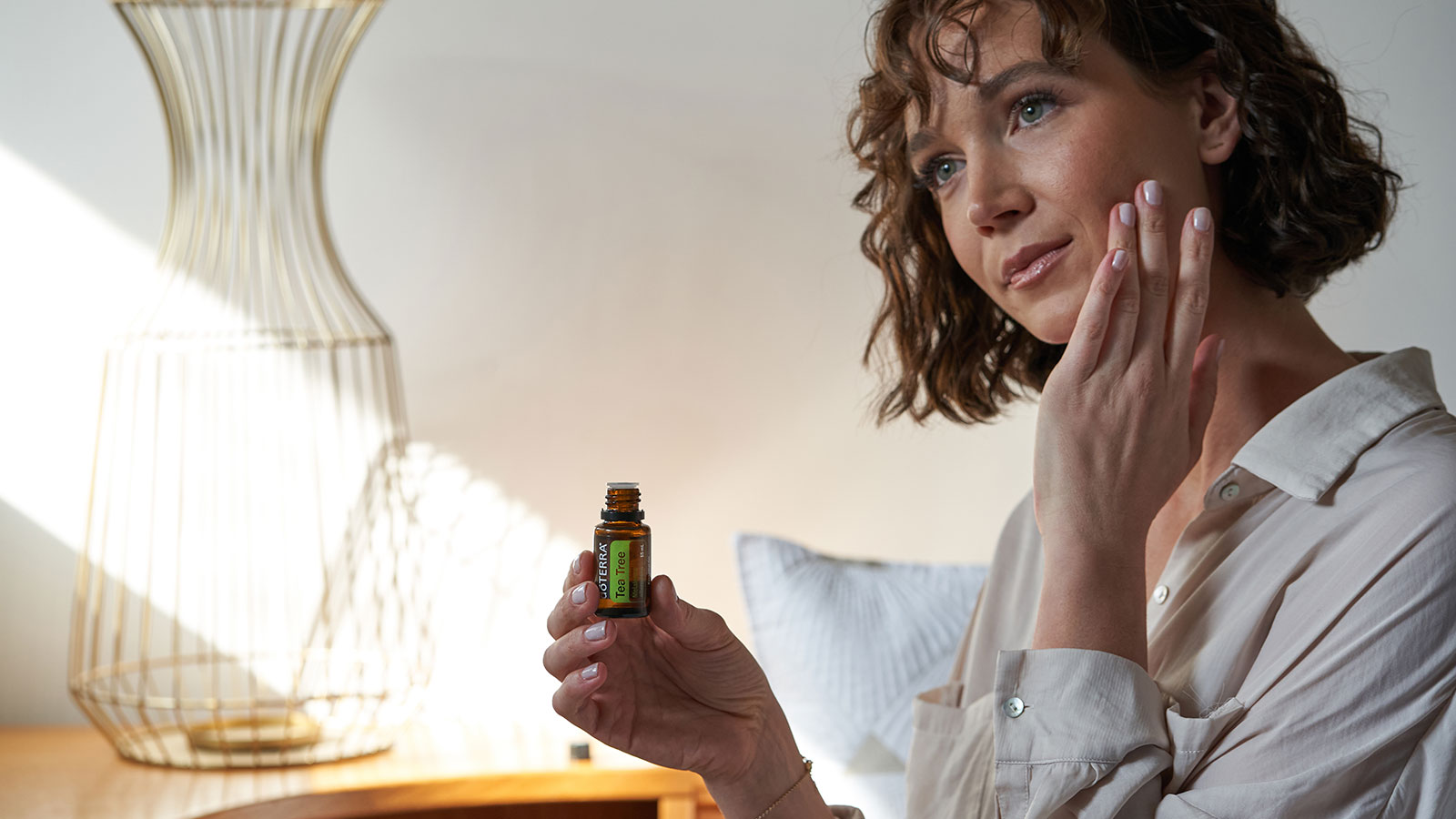 Woman Applying Tea Tree to Skin