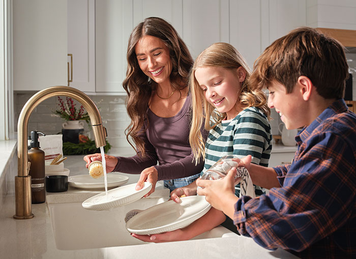 Mother and children washing dishes