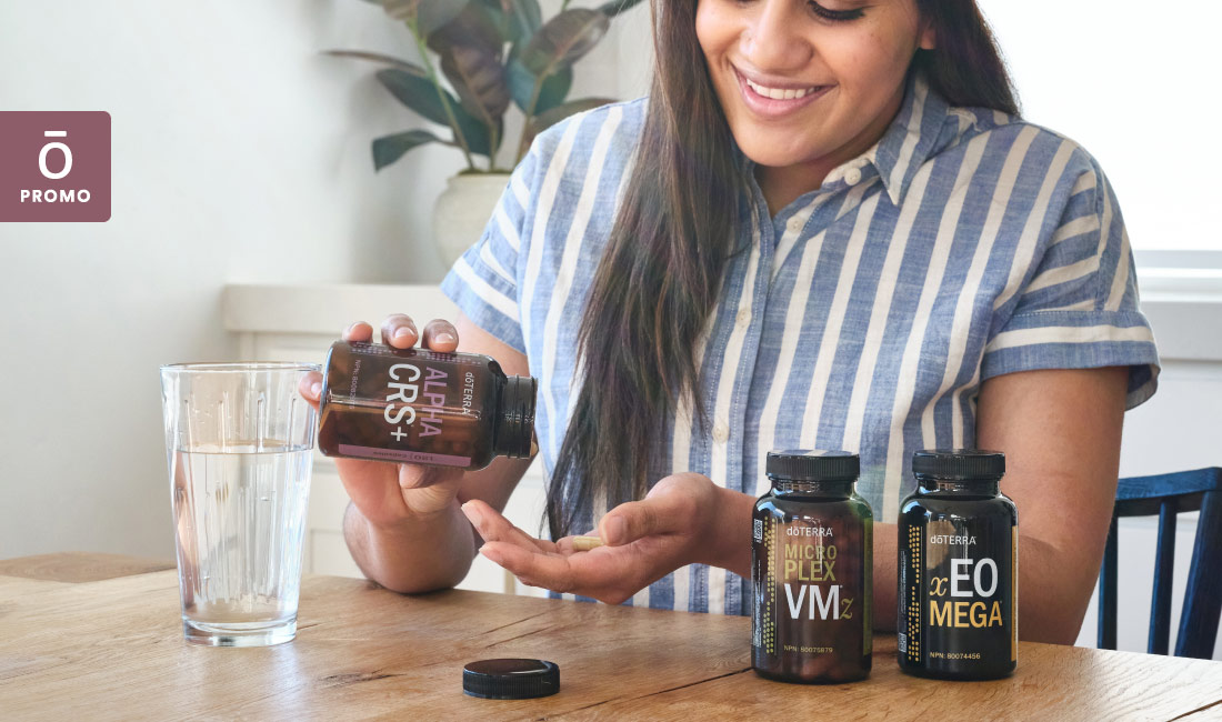 Woman at kitchen counter with doterra products.
