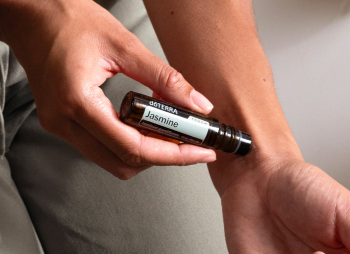 A person applying Jasmine to their arm