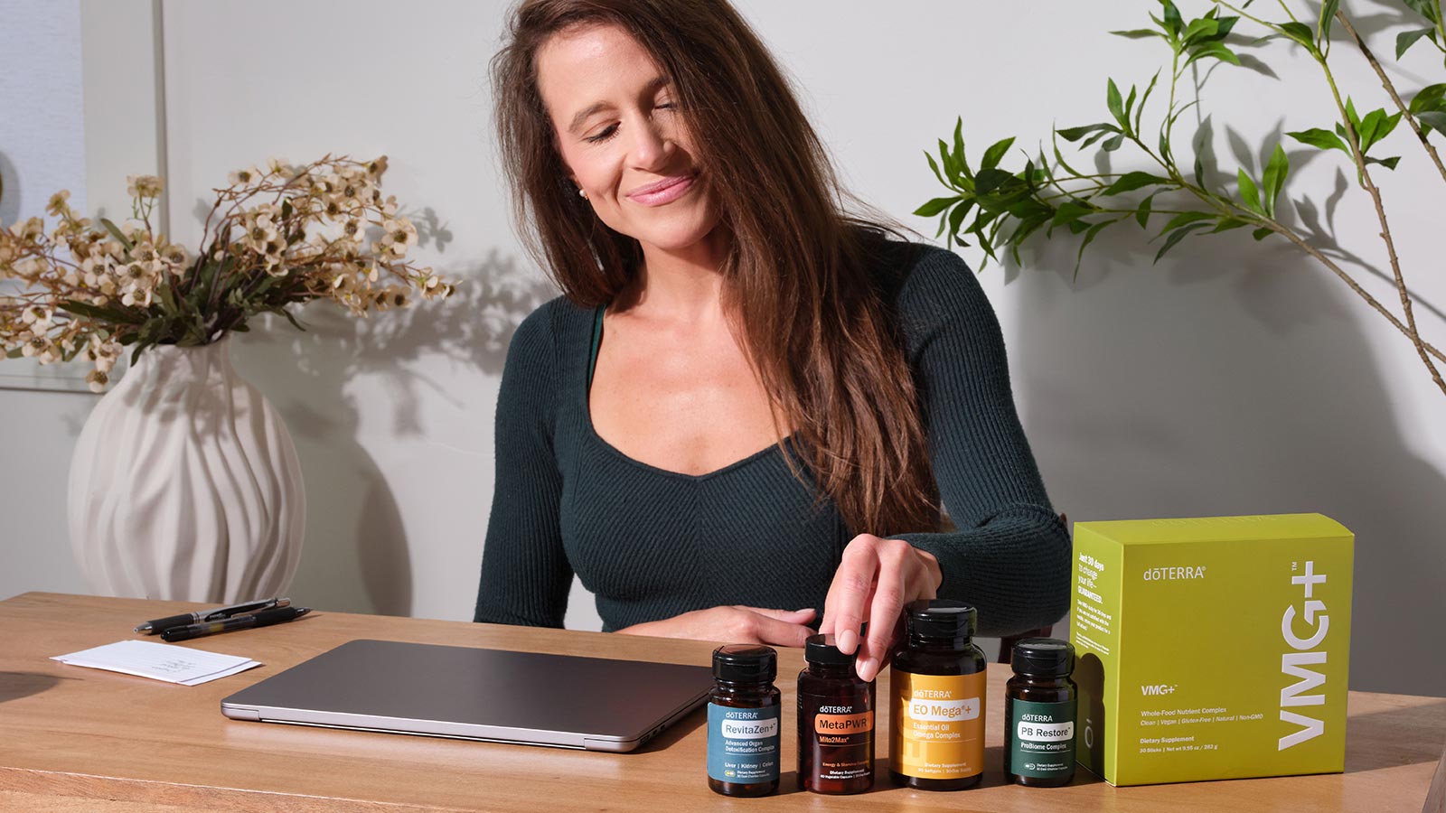 A woman behind a table that has various doTERRA products on top of it