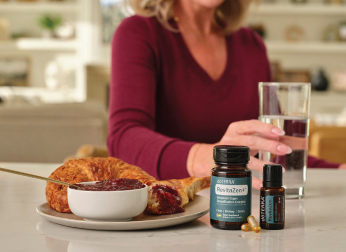 A woman standing behind a breakfast with RevitaZen products