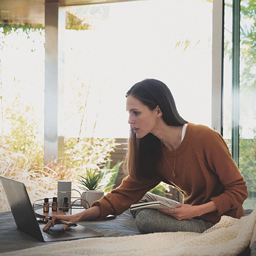 A woman inspecting a laptop screen