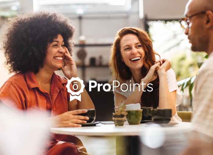 Three people talking at a table.