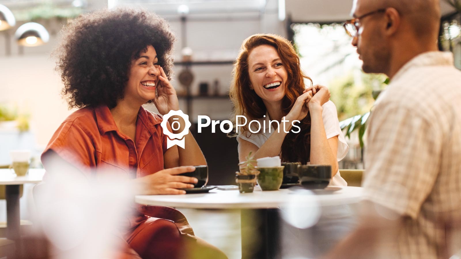 Three people talking at a table.