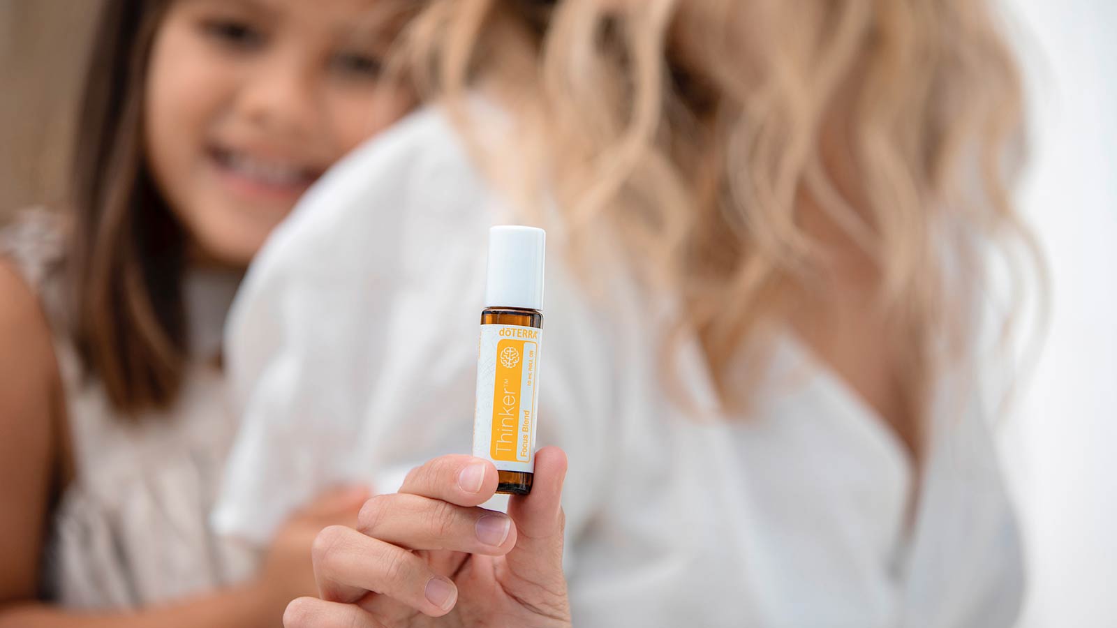 A child holding Thinker essential oil