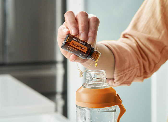 MetaPWR being dripped into a water bottle