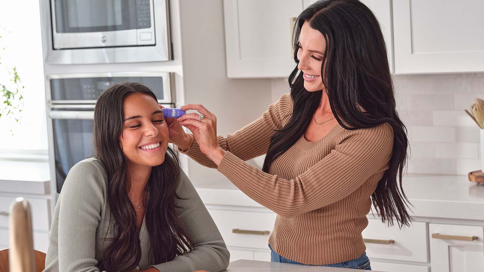A woman applying the PastTense stick to her daughter