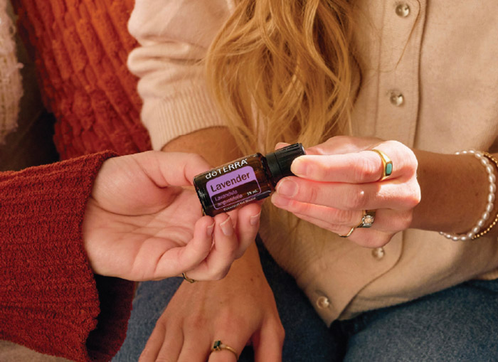 A woman holding Lavender essential oil