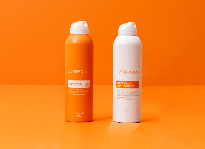 doTERRA After Sun and sunscreen with orange background.