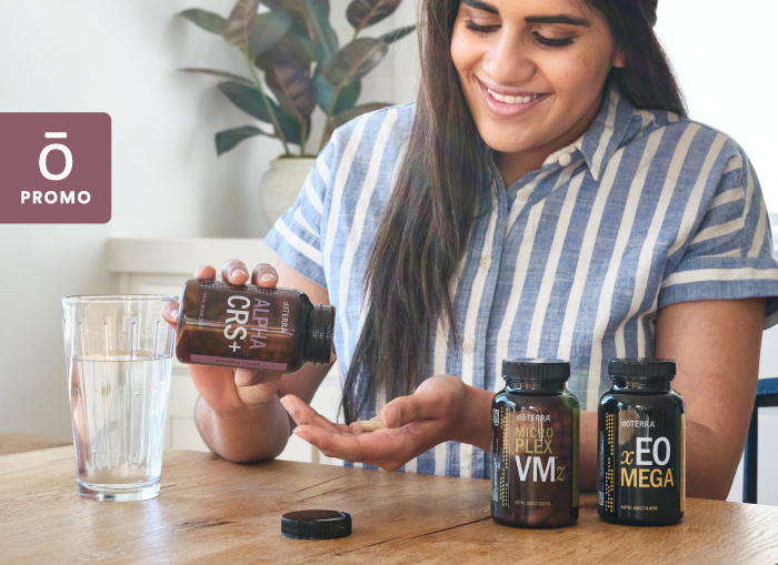 Woman at kitchen counter with doterra products.