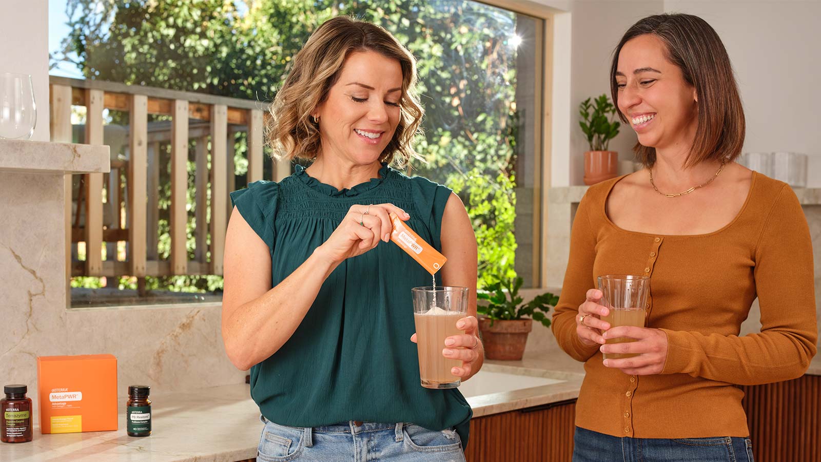 Two women drinking doterra health drinks