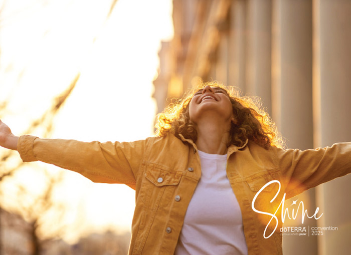 A woman raising her arms to the sun