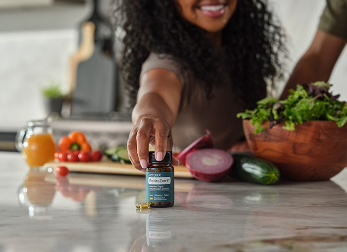 A table with fruit on it and a bottle of RevitaZen+