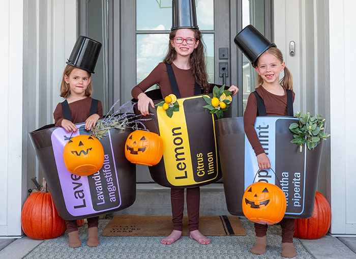 Three girls dressed up as doTERRA essential oils for Halloween