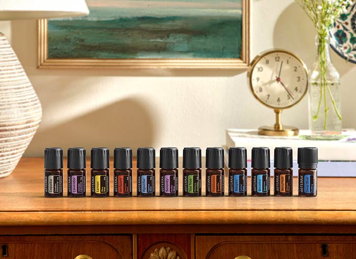 12 essential oils lined up on a table