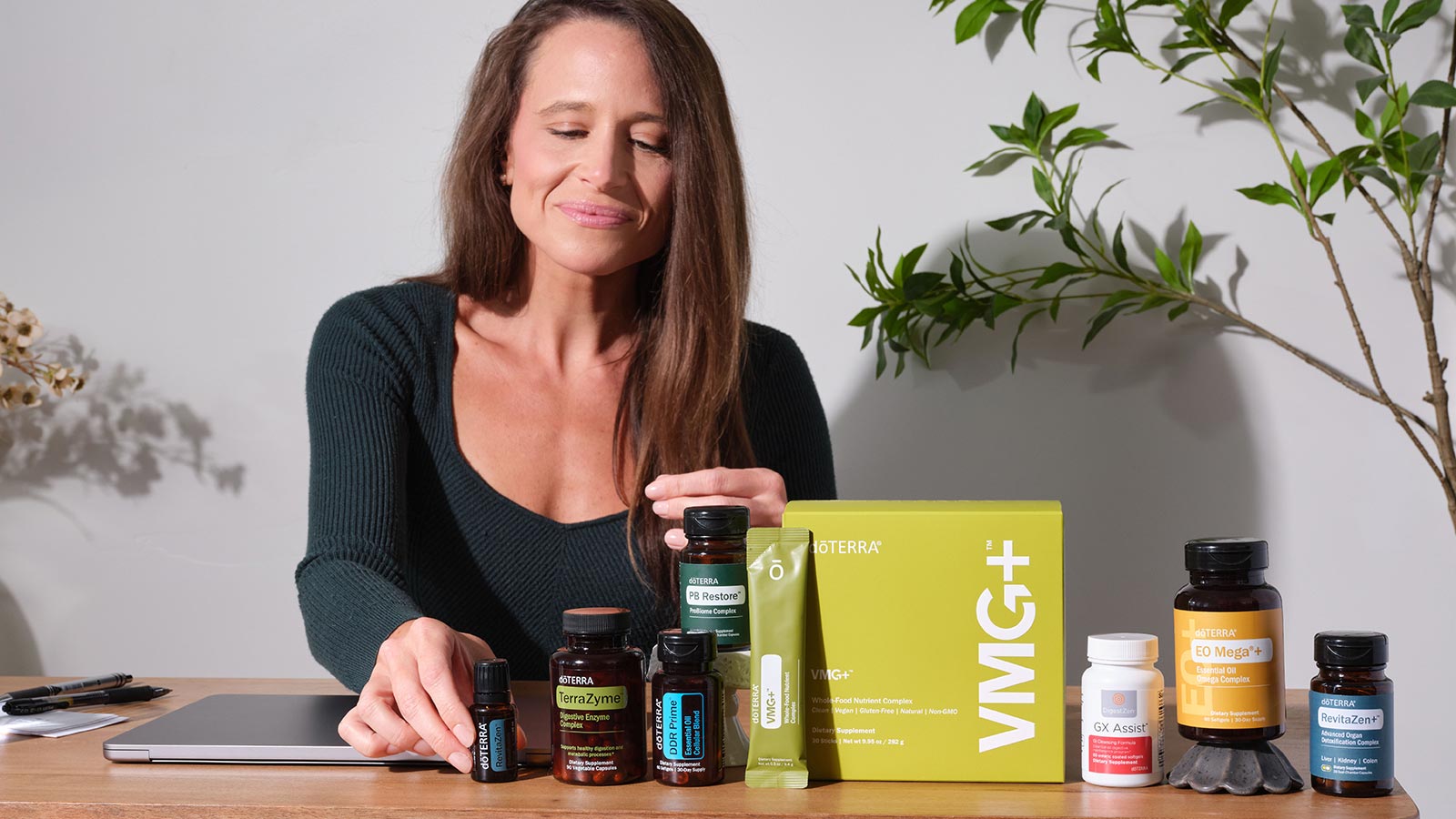A woman behind a table with various doTERRA products on it