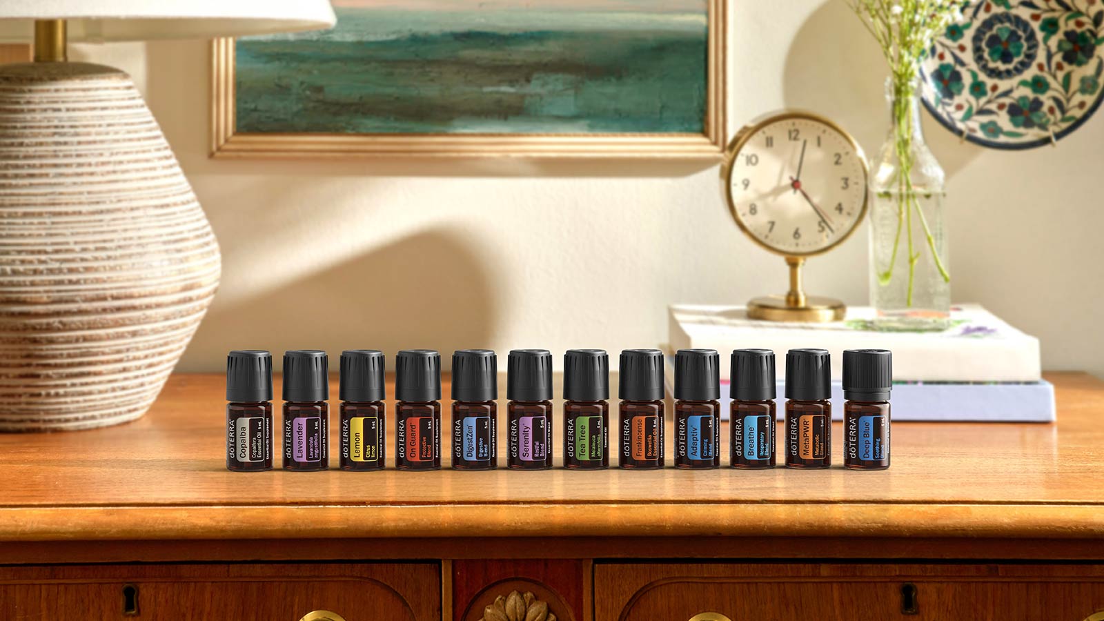 12 essential oils lined up on a table