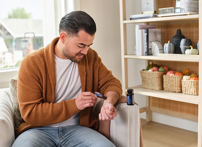 Man applying doTerra Adaptiv touch to arm