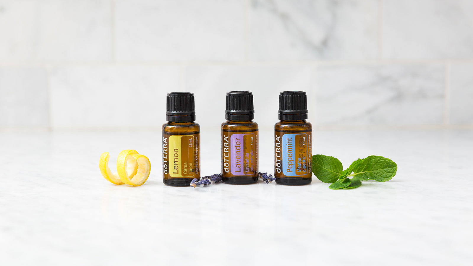 Essential oil bottles of lemon, lavender, and peppermint.