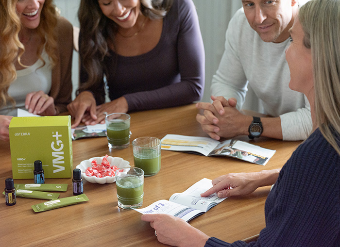People around a table with VMG and doTERRA essential oils