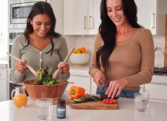 Two women preparing food with RevitaZen+ on the table