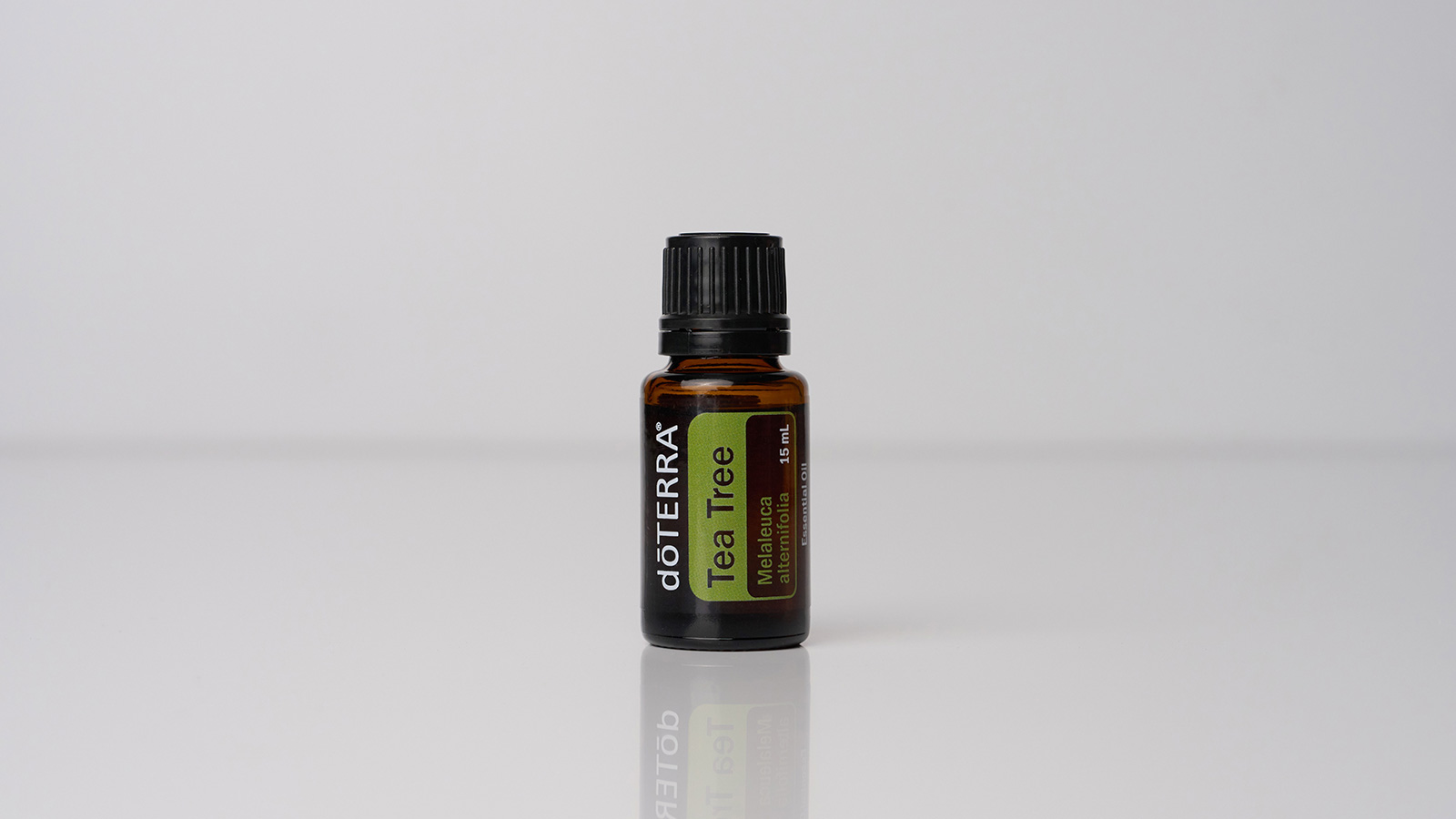 doTERRA Tea Tree essential oil bottle centered against a bright white background, emphasizing the oil’s clean, purifying nature and spotlighting the product.