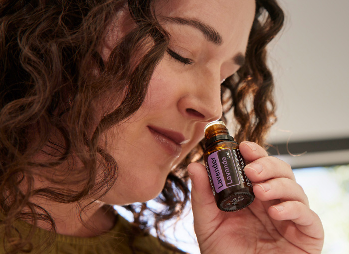 Woman Smelling an essential oil.